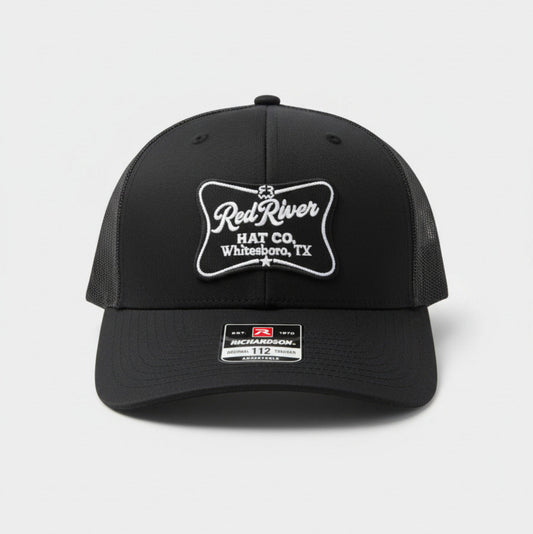 Black cap with 'Red River Hat Co' logo on a white background