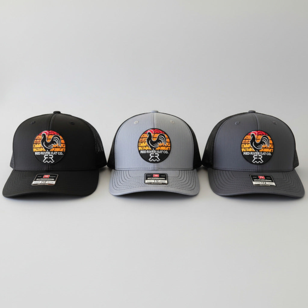 Three baseball caps with a rooster logo on a gray background