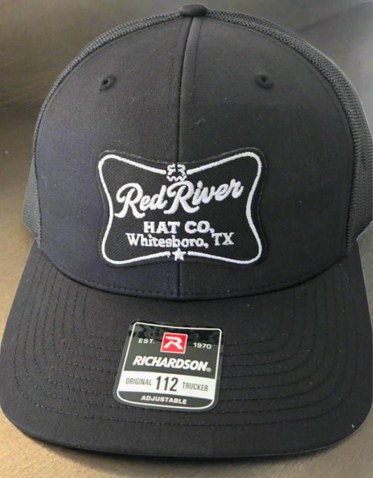 Black cap with 'Red River Hat Co' logo on a white background