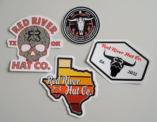 A set of four vinyl stickers from Red River Hat Co, featuring different designs including a skull logo, a bull illustration, and text-based logos.